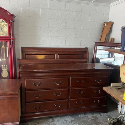 Sale Photo Thumbnail #4: Traditional cherry wood sleigh bed and matching six-drawer dresser set with brass bail handles.