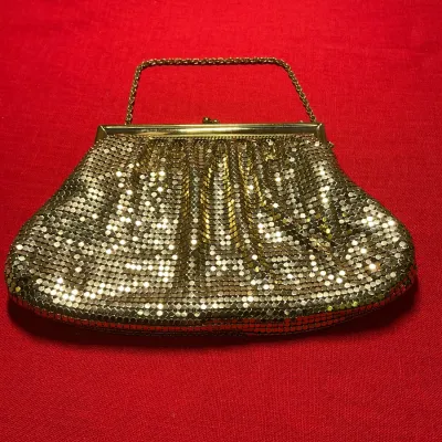 Vintage gold mesh evening bag with chain handle and kiss-lock closure.