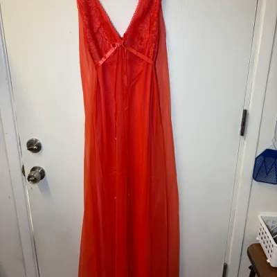 Vintage bright red floor-length nightgown featuring a lace bodice, V-neckline, and ribbon accent.