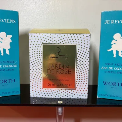Trio of boxed perfumes, including two 50ml Je Reviens by Worth Paris eau de cologne sprays and one 100ml Dorall Collection Jardin De Rose...
