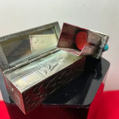 Vintage ornate metal lipstick case holder featuring an integrated mirror lid and turquoise cabochon slide accent.