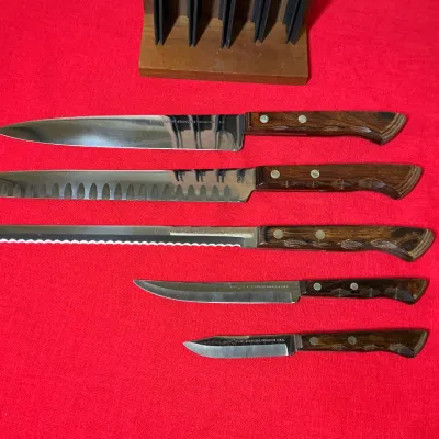 Vintage 5-piece Ekco Flint stainless vanadium cutlery set with wood handles and a wooden knife block.