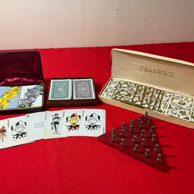 Vintage playing card sets in original boxes, including an I. Magnin & Co. set, accompanied by assorted Joker cards and a triangular...
