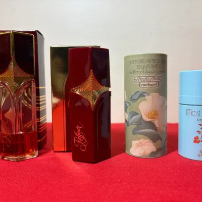 Collection of vintage fragrance items, including Raffinée perfume bottles with original boxes, Cacharel Anaïs Anaïs dusting powder, and...