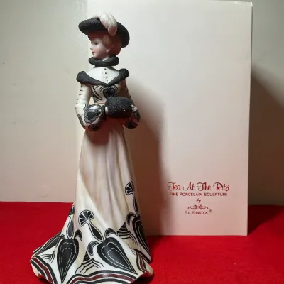 Lenox 'Tea At The Ritz' fine porcelain sculpture figurine depicting an Edwardian-era woman, displayed with its original box.