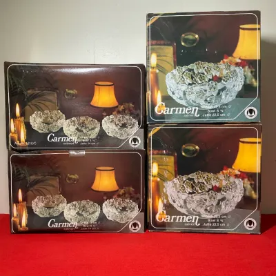 Four boxed Carmen satin-finish crystal bowls featuring embossed floral motifs, including two larger 8.75-inch bowls and two sets of...