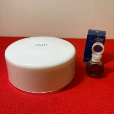 Vintage Coty Élan dusting powder container paired with a small perfume bottle and original box.