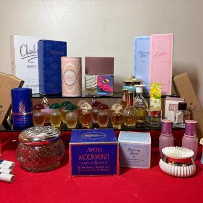 Collection of vintage cosmetics, perfumes, and bath products, featuring items from Avon, Revlon Charlie White, and Cotillion in original...
