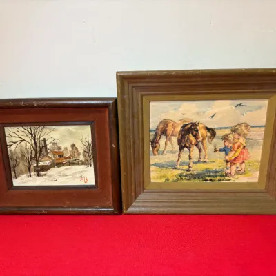 Two vintage framed paintings featuring a winter farm landscape scene on the left and two children with horses in a field on the right.