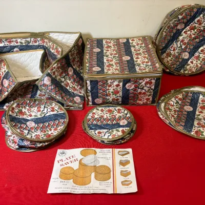 Set of quilted floral-pattern dish storage cases with original instruction insert, including zippered plate and platter savers.