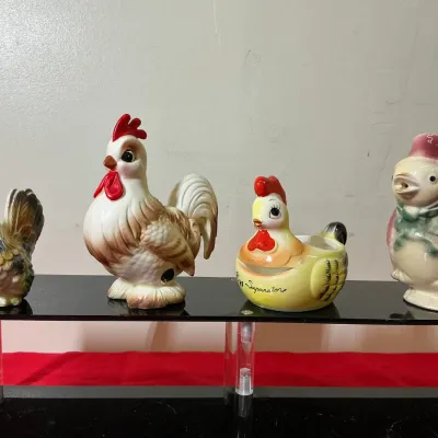 Collection of four vintage ceramic poultry kitchen accessories, including salt and pepper shakers and a chicken-shaped egg separator.