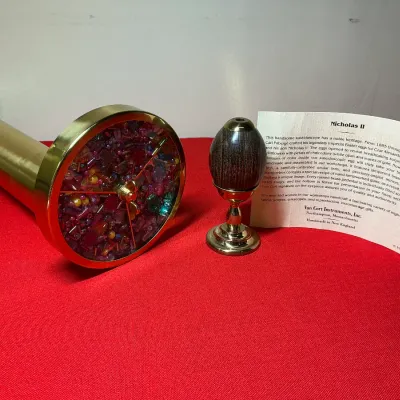 Van Cort Instruments "Nicholas II" brass kaleidoscope with a wooden egg-shaped eyepiece and original informational insert card.