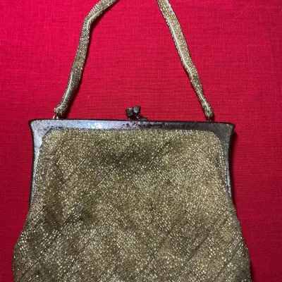 Vintage gold seed bead evening bag featuring a geometric diamond lattice pattern, metal frame, kiss-lock closure, and matching beaded strap.