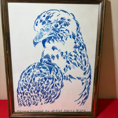 Framed stamp collage artwork depicting an eagle, created by artist Harry Wang using blue postage stamps.