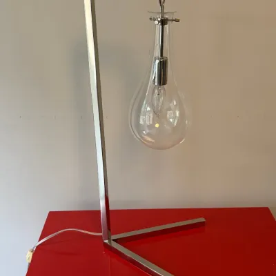 Sale Photo Thumbnail #32: Modern chrome-finished table lamp featuring a right-angle frame and a suspended teardrop-shaped clear glass shade.