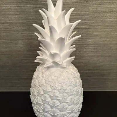 Sale Photo Thumbnail #70: White ceramic or resin pineapple decorative figurine with detailed textured surface.