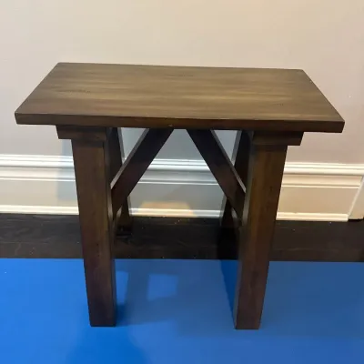 Sale Photo Thumbnail #22: Rustic dark wood end table featuring an A-frame or cross-brace design base.