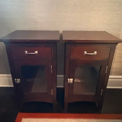 Sale Photo Thumbnail #19: Pair of dark-stained wooden nightstands featuring a single top drawer, silver-tone hardware, and a glass-front cabinet door.