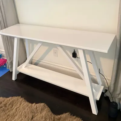 Sale Photo Thumbnail #50: Modern white painted console table featuring an A-frame trestle base and lower display shelf.