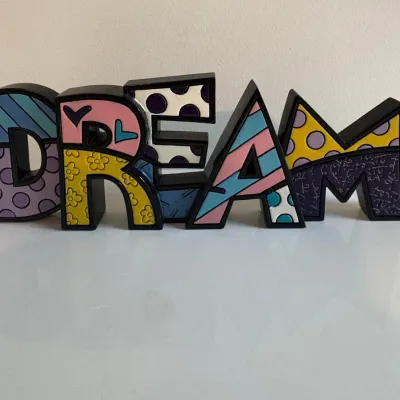 Sale Photo Thumbnail #56: Romero Britto style resin "DREAM" block sign figurine with colorful pop art patterns.