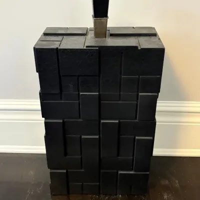 Sale Photo Thumbnail #80: Mid-century brutalist style black wooden box featuring geometric relief panels and a central top finial.