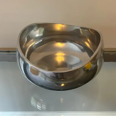 Sale Photo Thumbnail #37: Polished stainless steel double-walled serving bowl with an asymmetrical, curved rim.