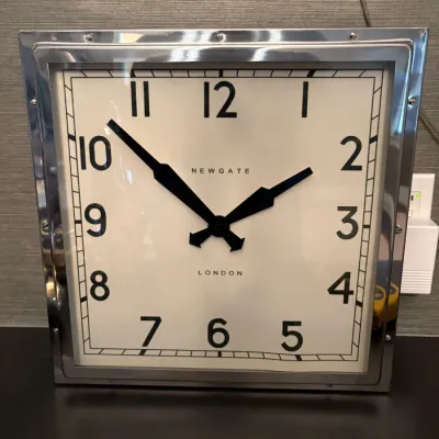 Sale Photo Thumbnail #73: Square chrome-framed wall clock by Newgate London featuring Art Deco-style black numerals and hands.