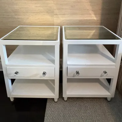 Sale Photo Thumbnail #46: Pair of modern white lacquered nightstands featuring glass insert tops, open lower shelving, and single drawers with chrome ring pulls.