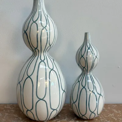 Sale Photo Thumbnail #25: Pair of contemporary white ceramic double-gourd vases with blue geometric chain link patterns, displayed in graduated sizes.