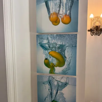 Sale Photo Thumbnail #78: Set of three modern canvas prints featuring high-speed photography of fruit splashing into water, mounted vertically on a wall.