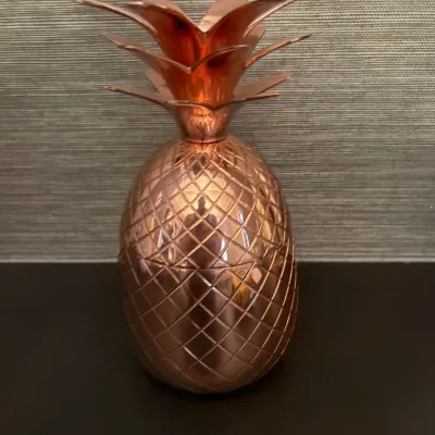 Sale Photo Thumbnail #71: Copper-plated pineapple-shaped cocktail tumbler with a removable leafy crown lid.