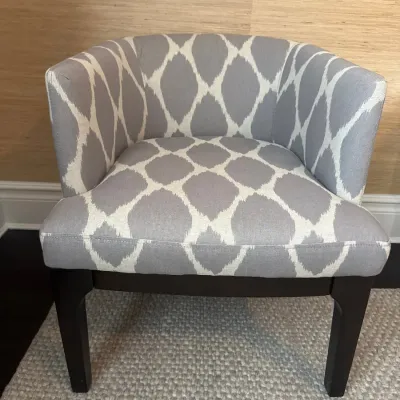 Sale Photo Thumbnail #43: Modern tub chair featuring grey and white ikat pattern upholstery set on dark finished wooden legs.
