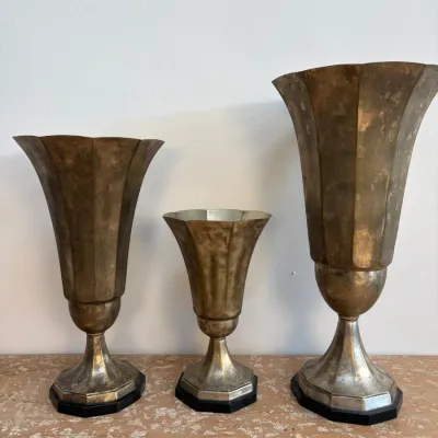 Sale Photo Thumbnail #83: Set of three vintage Art Deco brass trumpet vases with fluted tops, pedestals, and black bases.