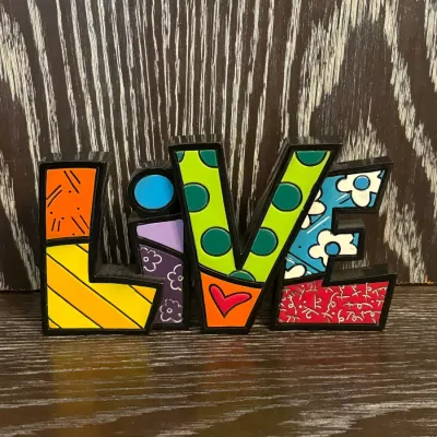 Sale Photo Thumbnail #57: Romero Britto-style colorful pop art "LIVE" tabletop sign featuring bold patterns and vibrant colors.
