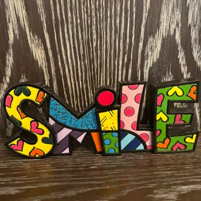 Sale Photo Thumbnail #60: Romero Britto style colorful block sign spelling out "SMILE" with bold pop art patterns.