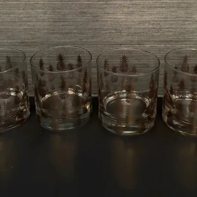Sale Photo Thumbnail #75: Set of four mid-century rocks glasses featuring a gold pineapple motif.