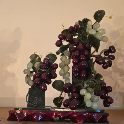 Sale Photo Thumbnail #51: Vintage Asian carved jade and stone grape cluster tree sculpture mounted on a carved wooden base.