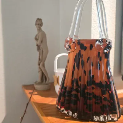 Sale Photo Thumbnail #83: Decorative hand-blown art glass purse vase with tortoiseshell pattern and clear glass handles.