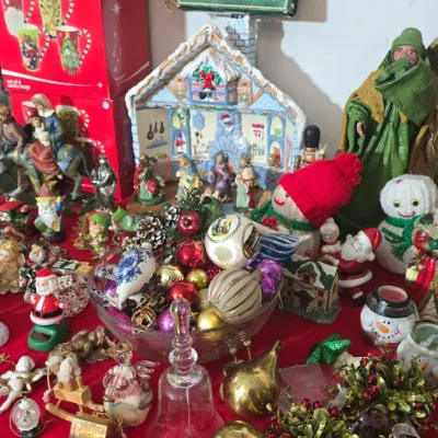 Sale Photo Thumbnail #28: Collection of holiday decorations, featuring a clear glass bowl filled with colorful glass ornaments, nativity figurines, snowmen, and a boxed vintage 10-light star tree topper.