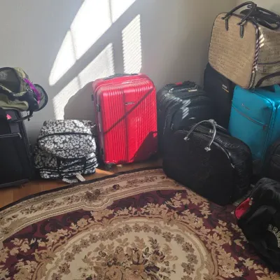 Sale Photo Thumbnail #105: Collection of assorted modern luggage, duffel bags, and travel totes, including hard-shell suitcases, soft-side rolling bags, and a Jordan duffel.