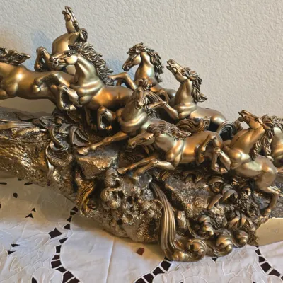 Sale Photo Thumbnail #48: Large bronze-finished resin sculpture depicting eight galloping horses on a rocky terrain base.