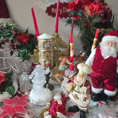 Sale Photo Thumbnail #37: Collection of Christmas decorations including Santa figurines, red taper candles, a '12 Days of Christmas' pillar candle, brass candlesticks, and beaded star ornaments.