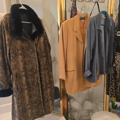 Sale Photo Thumbnail #65: Collection of vintage women's outerwear and blazers, including a snakeskin print coat with black faux fur collar and trim, a camel-colored blazer, and a slate blue jacket.