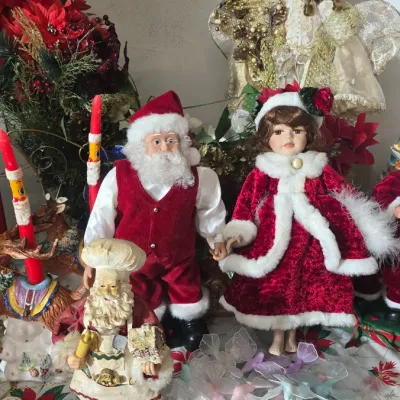 Sale Photo Thumbnail #38: Collection of Christmas decor including porcelain angel dolls, Santa Claus figurines, and colorful clip-on bird ornaments.