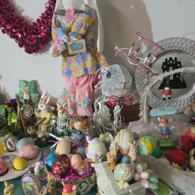 Sale Photo Thumbnail #20: Collection of spring and Easter decorations, including plush standing rabbits, decorative eggs, figurines, and a foil heart wreath.