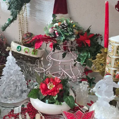 Sale Photo Thumbnail #36: Collection of vintage Christmas decorations, including plastic light-up star toppers, decorative candles, artificial floral arrangements, and a frosted glass Santa figurine.