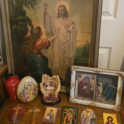 Sale Photo Thumbnail #80: Collection of Christian religious artwork and memorabilia, including a large framed print of Jesus and Mary Magdalene, framed icons, crucifixes, and decorative figurines.