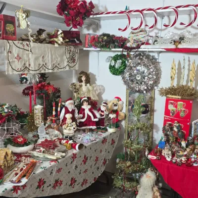 Sale Photo Thumbnail #43: Large collection of vintage and holiday Christmas decorations, including Santa figurines, porcelain dolls, nativity scenes, wreaths, and novelty candles.