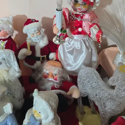 Sale Photo Thumbnail #32: Collection of vintage holiday decorations including animated Mrs. Claus and Santa figures, ceramic figurines, and a lighted acrylic reindeer.