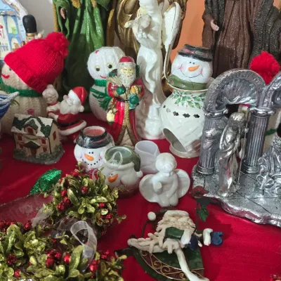 Sale Photo Thumbnail #29: Collection of holiday decorations, including Nativity figures, angels, snowmen, Santa Claus figurines, and Christmas tree ornaments.